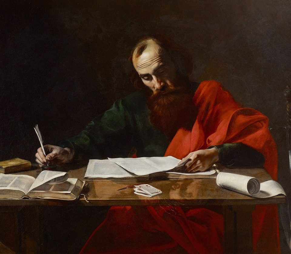 Saint Paul Writing His Epistles, by Valentin de Boulogne: the apostle in red, pen in hand.
