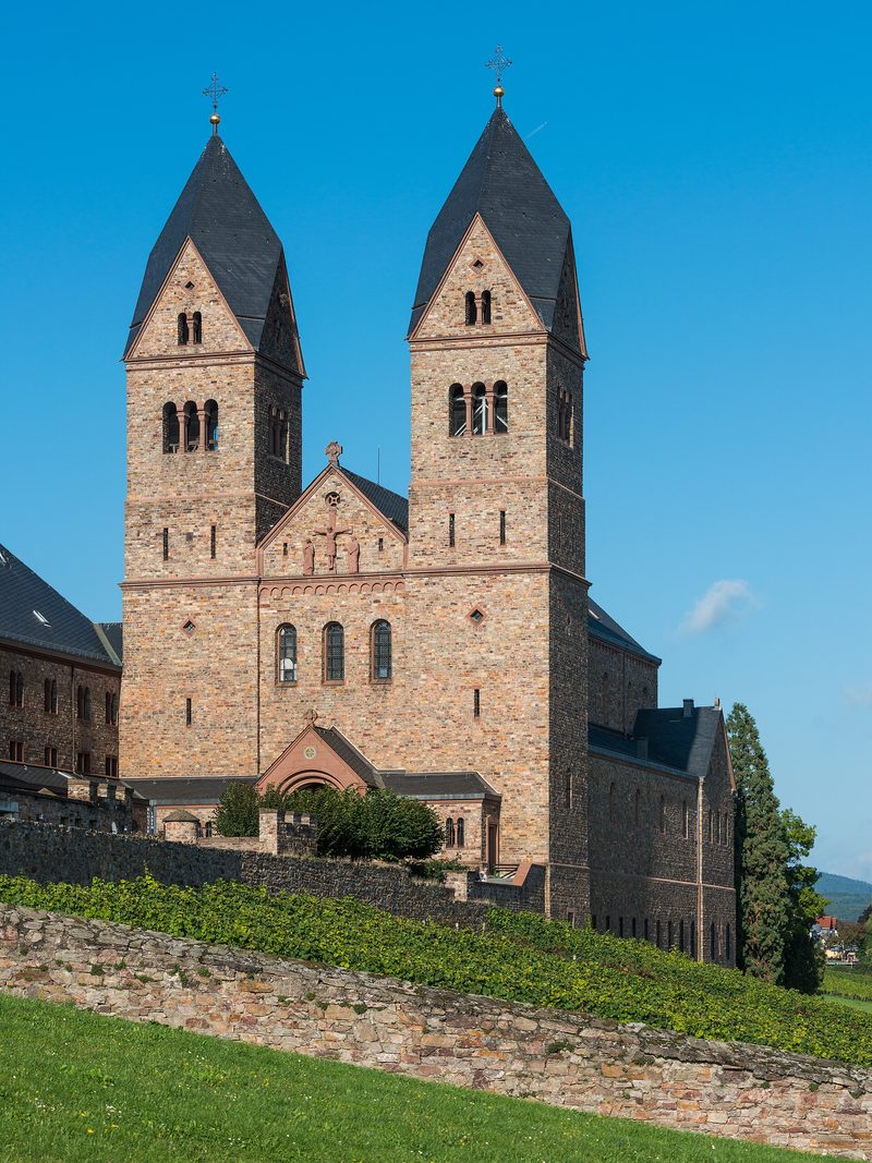 The Abbey of St Hildegard above Rüdesheim: a red sandstone church with two square towers over vineyards.