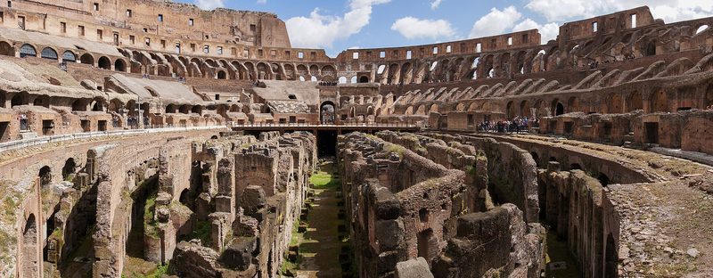 The interior of the Colosseum in Rome, its tiers of broken arches open to the sky.