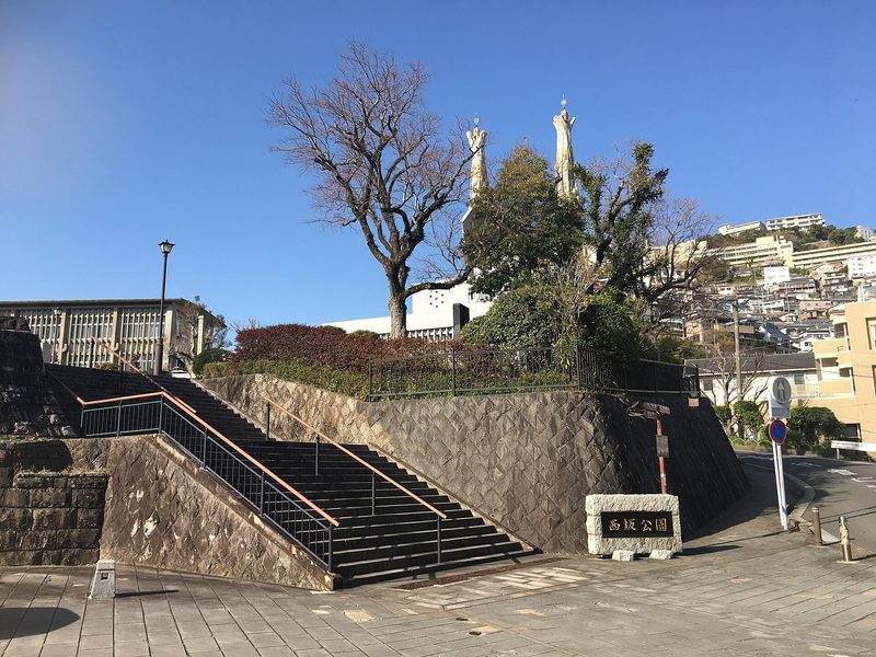 The Twenty-Six Martyrs Monument on Nishizaka Hill in Nagasaki: a stone stairway and garden beneath the memorial.