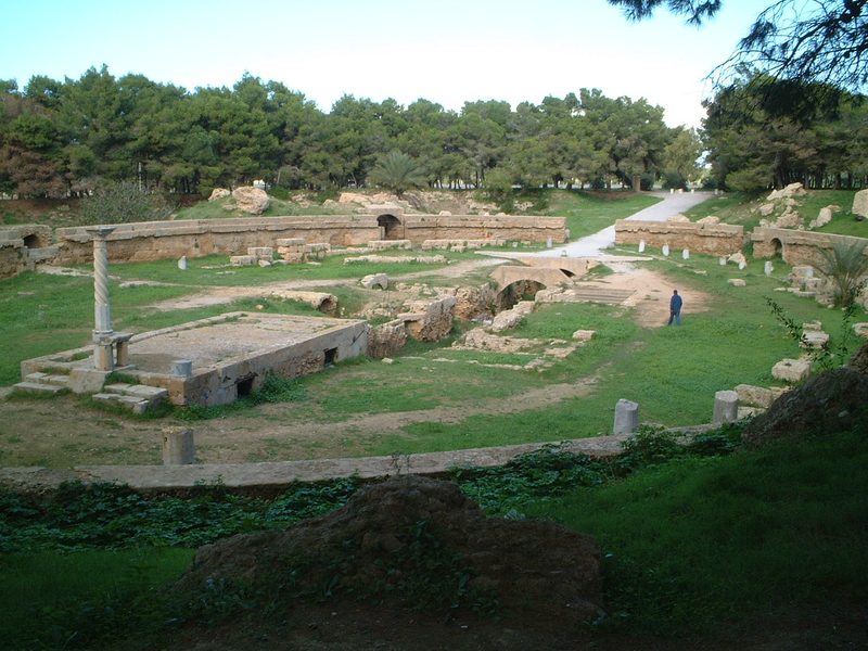 The ruined amphitheatre of Carthage, Tunisia: grassy terraces and stone arches around an oval arena.